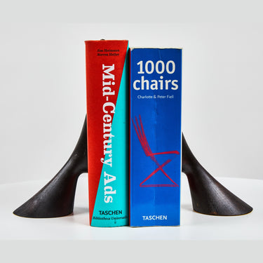 Two bookends with 'Mid-Century Ads' and '1000 Chairs' books on a white background