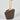 Decorative vase with a gold stand on a light gray background