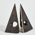 Two triangular metal bookends on a light gray background