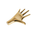 brass hand-shaped paperweight sculpture on a white background