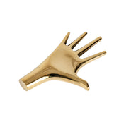brass hand-shaped paperweight sculpture on a white background