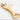 Gold bottle opener with claw-like design on a white background
