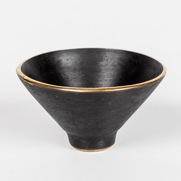 Black brass bowl on a white background