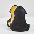 Black and gold bookend on a white background
