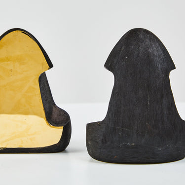 Two blackened brass and polished brass bookends detail view
