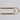 Gold paper clip on a white background