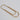 Gold paper clip on a light gray background