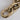 Close-up of a gold chain link paperweight on a light gray background