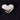 Heart-shaped polished nickel paperweight on a textured black background