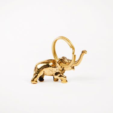 Gold elephant pendant on a white background