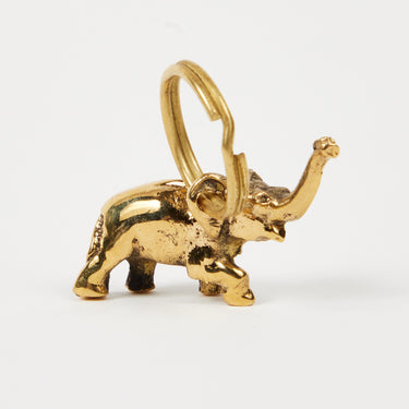 Gold elephant-shaped keychain on a white background
