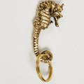 Gold seahorse-shaped keychain on a light gray background