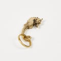 Gold seahorse keyring on a white background