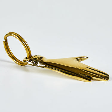 Gold hand-shaped keychain on a white background