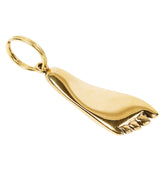 Gold foot-shaped pendant on a white background