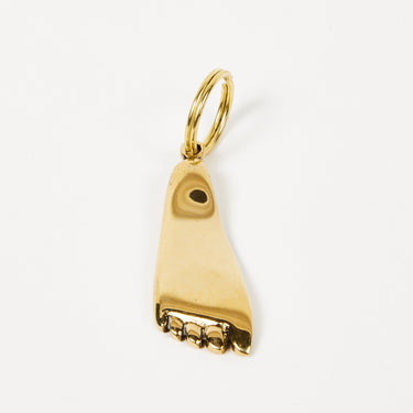 Gold shoe charm on a white background