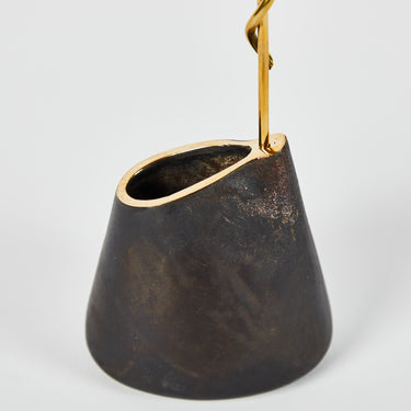 Black vase with gold rim on a white background