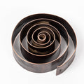 patinated brass swirl design desktop pen holder on a white background