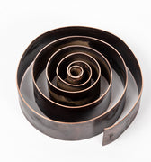 patinated brass swirl design desktop pen holder on a white background