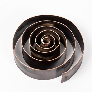 patinated brass swirl design desktop pen holder on a white background