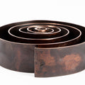 patinated brass desktop swirl penholder by carl aubock with concentric circles on a white background