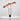 Vase with dried orange flowers on a white surface and light gray background