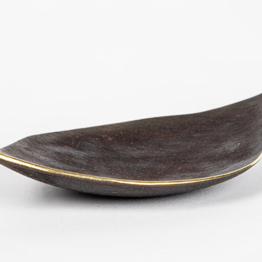 Decorative dish with gold accents on a white background