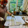 man working on brass hand bottle openers in vienna workshop carl auböck