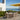 Outdoor dining area with table and chairs on a deck overlooking the ocean.