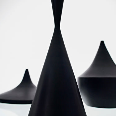 Three black pendant shapes of varying sizes on a white background