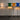 Four colorful floor lamps with different colored shades on a gray background