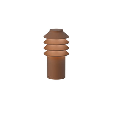 Cylindrical corten red pathway light with layered shade on a white background