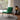Green armchair in a room with a lamp and window