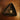 Triangular dark brown dish with a gold star-shaped pendant on a wooden surface