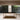 Modern dining table with a black top in a minimalistic room with large windows.