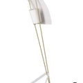 Modern floor lamp with white shade and gold metal legs on a white background