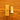 A Tala Two Brighten LED bulb next to its brown kraft paper packaging box, placed on a wooden surface.