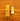 A Tala Two Brighten LED bulb next to its brown kraft paper packaging box, placed on a wooden surface.