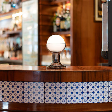Wooden bar counter with decorative tile edge and smoke glass gelato lamp carlo nason