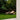 Beige outdoor lounge chair on a grassy area with trees in the background
