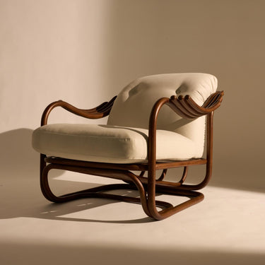 Vintage-style armchair with wooden frame and white cushion on a beige background