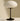 Table lamp with a white shade and black base on a neutral background