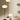 Set of three modern floor lamps with white lampshades on a neutral background