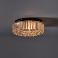 Ceiling light fixture with ribbed glass design on a dark background