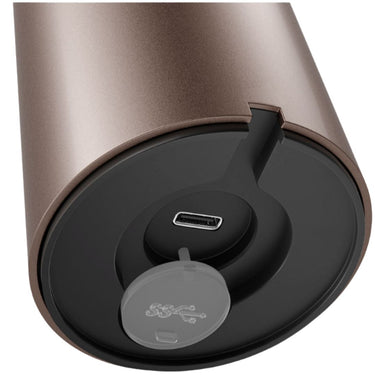 Close-up of a cylindrical rechargable light with a USB port and lock mechanism on a white background