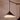 A modern pendant light with a black metal cone shade and a warm white frosted glass diffuser, suspended from a wooden ceiling fixture against a beige wall.