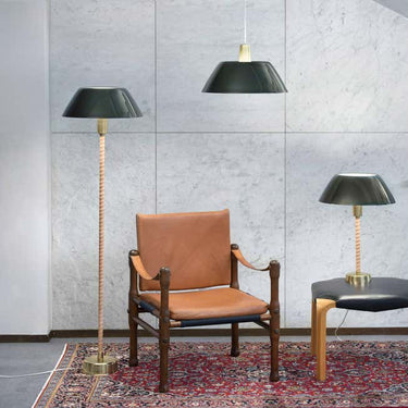 Lisa Johansson-Pape 'Senator' Floor Lamp for Innolux Oy 2 Brown leather chair with two black lamps against a concrete wall by Two Enlighten