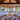 Dining room with wooden ceiling, large windows, and a round table with chairs.