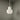 Small white lamp on a gray surface with a neutral background