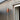 Copper wall-mounted light fixture on a wooden exterior wall.